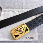 Prada belt buckle detail on dark leather strap with gold PRADA plate