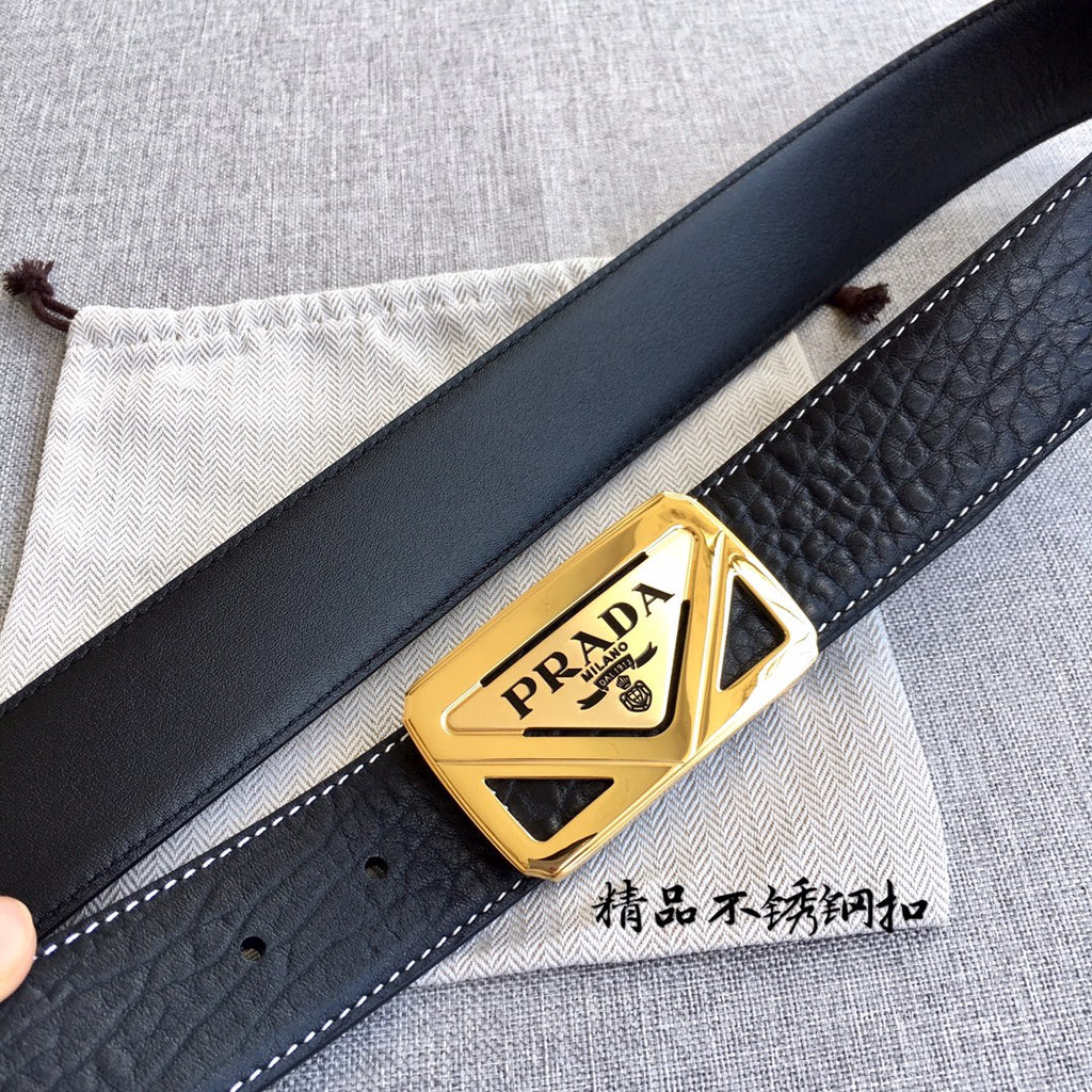 Prada belt with black strap and gold logo buckle, shown at an angle