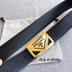 Prada belt with black strap and gold logo buckle, shown at an angle