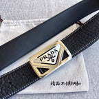 Prada belt with black textured leather and gold triangular logo buckle, angled view