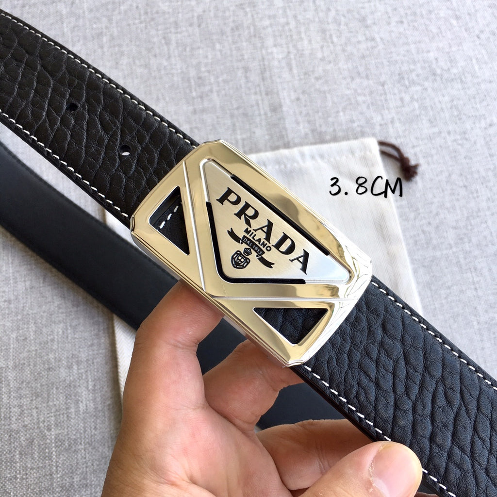 Prada belt buckle detail on black leather strap with gold-toned metal frame
