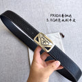 Prada leather belt with black strap and gold-toned triangular buckle in close-up