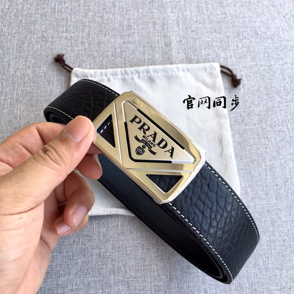 Prada black leather belt with gold-toned buckle held in hand, side view