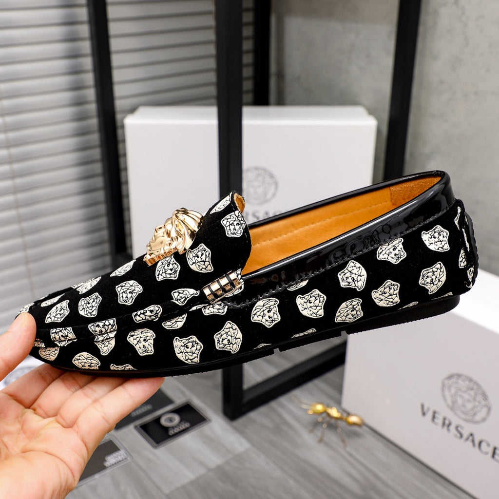 Versace luxury loafers, black slip-on with white pattern print and gold lion emblem