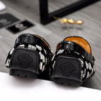 Versace luxury loafers rear view, glossy black with embossed logo on heel