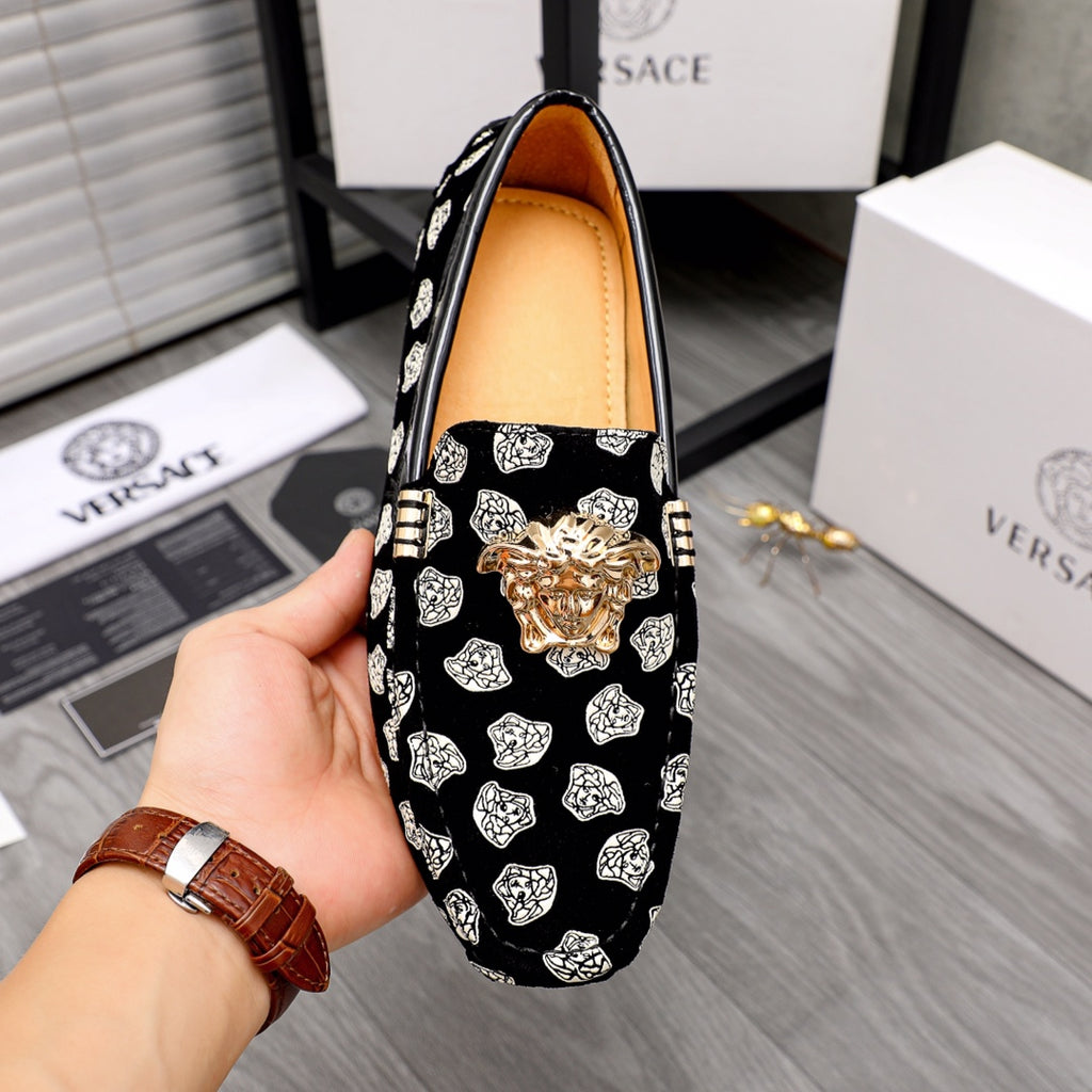 Versace luxury loafer, black with white pattern print, gold lion head at center