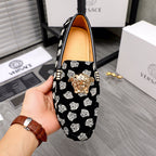 Versace luxury loafer, black with white pattern print, gold lion head at center