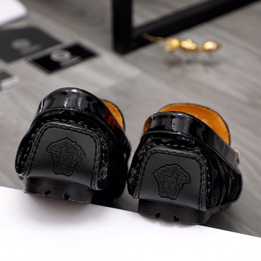 Black leather loafer heels with embossed Medusa logos and glossy finish