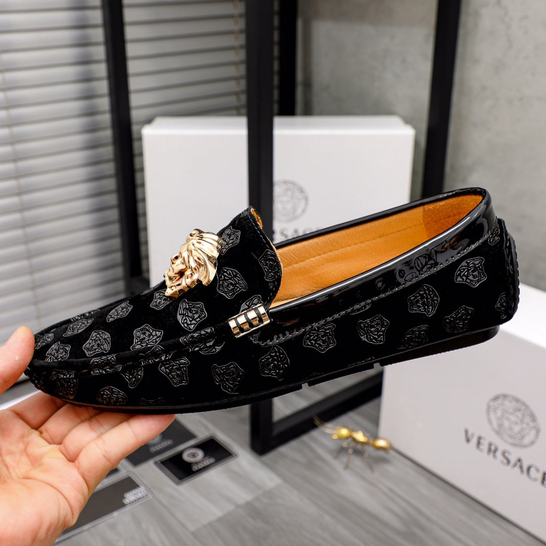 Black luxury loafers side view with gold Medusa emblem and buckle detail
