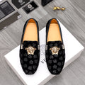 Black patterned luxury loafers with gold Medusa emblem and decorative buckle