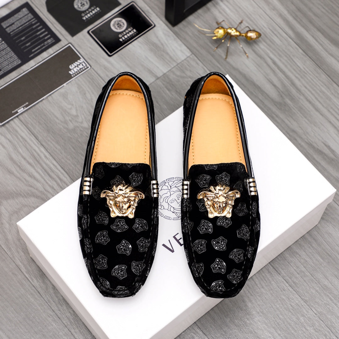 Black patterned luxury loafers with gold Medusa emblem and decorative buckle