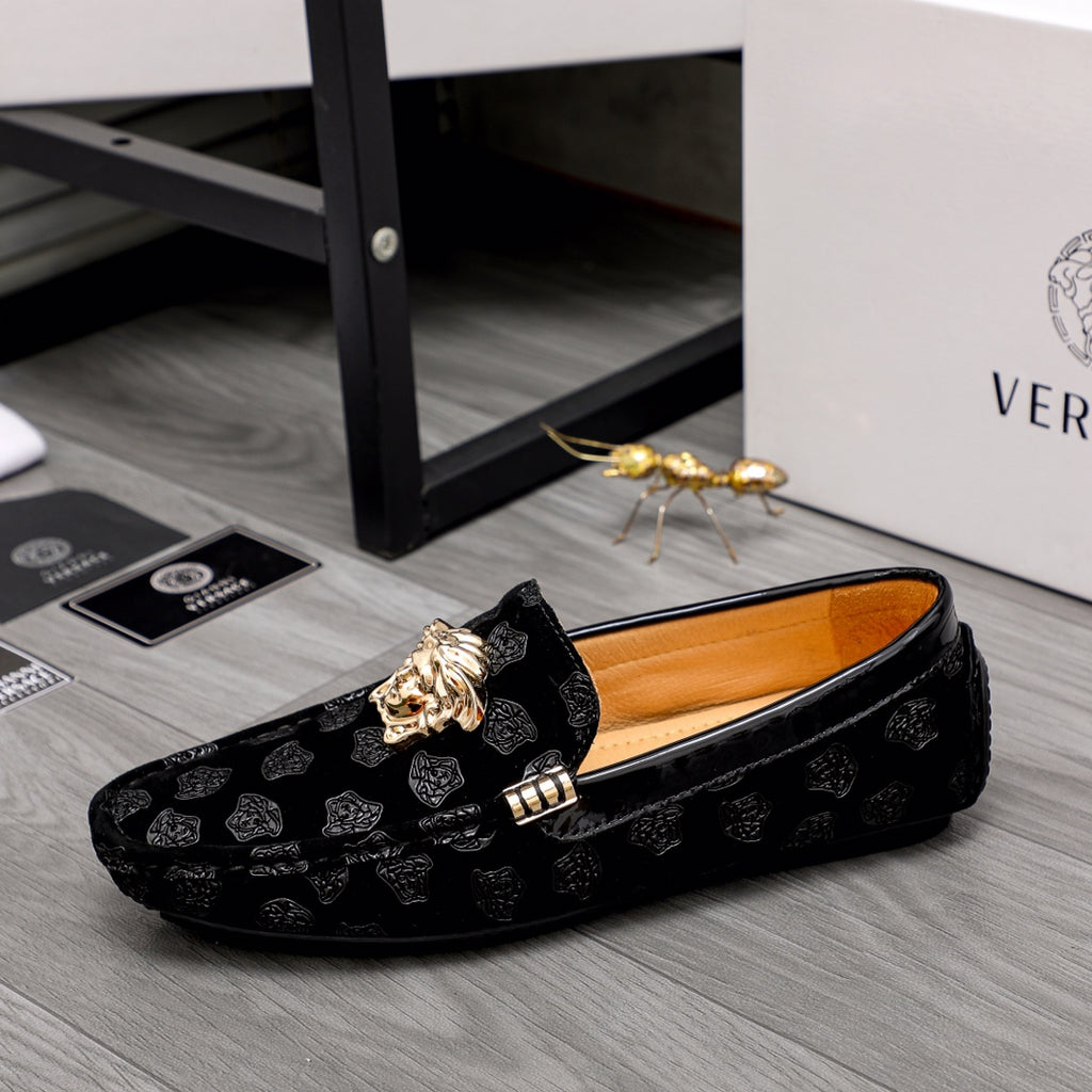 Black luxury loafers with gold Medusa emblem, side strap and patterned upper