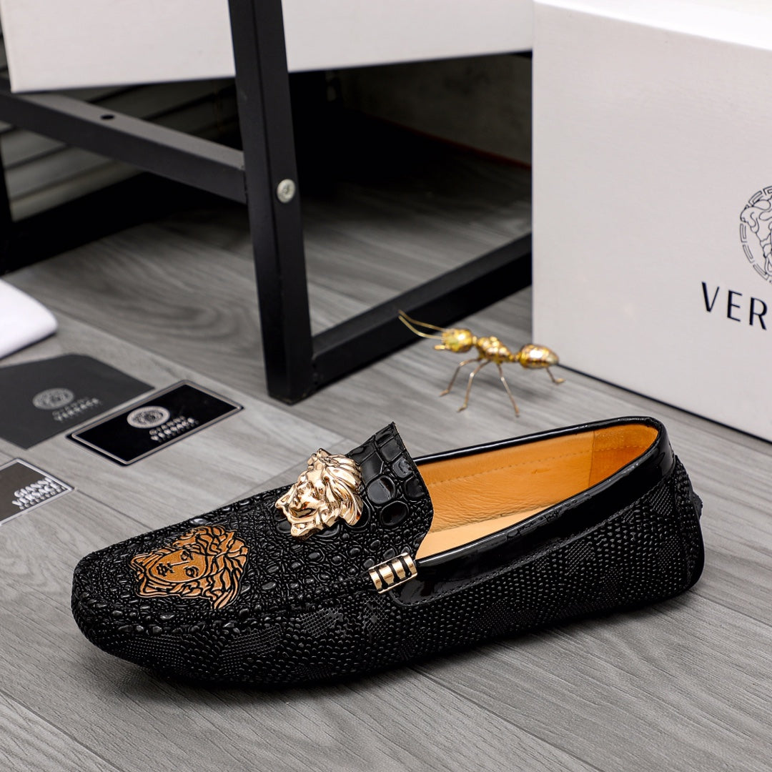 Black loafer with gold-tone hardware, embossed texture, and Medusa emblem