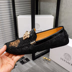 Black loafer with gold-tone bit detail and embossed Medusa face on vamp