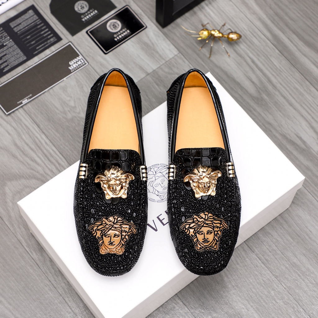 Black Versace-style loafers with gold Medusa emblem and studded accents