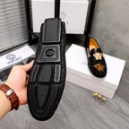Black loafer sole and side view with Greek key pattern and Medusa logo