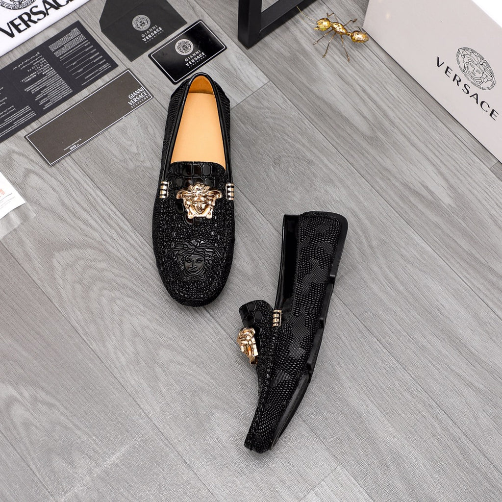 Versace black loafers pair with gold Medusa head ornaments, dark uppers