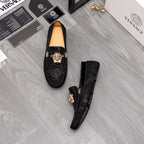 Versace black loafers pair with gold Medusa head ornaments, dark uppers