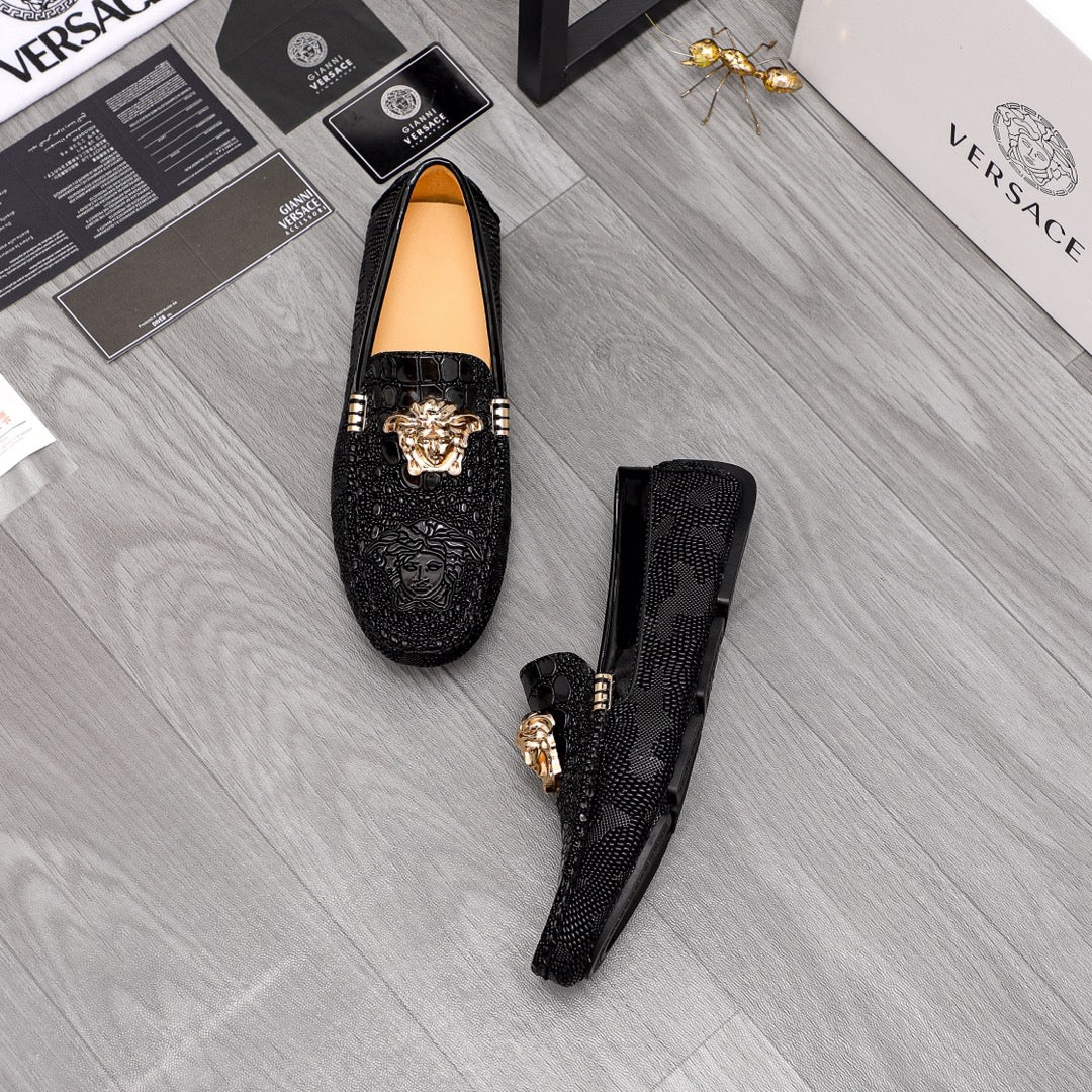 Versace black loafers pair with gold Medusa head ornaments, dark uppers