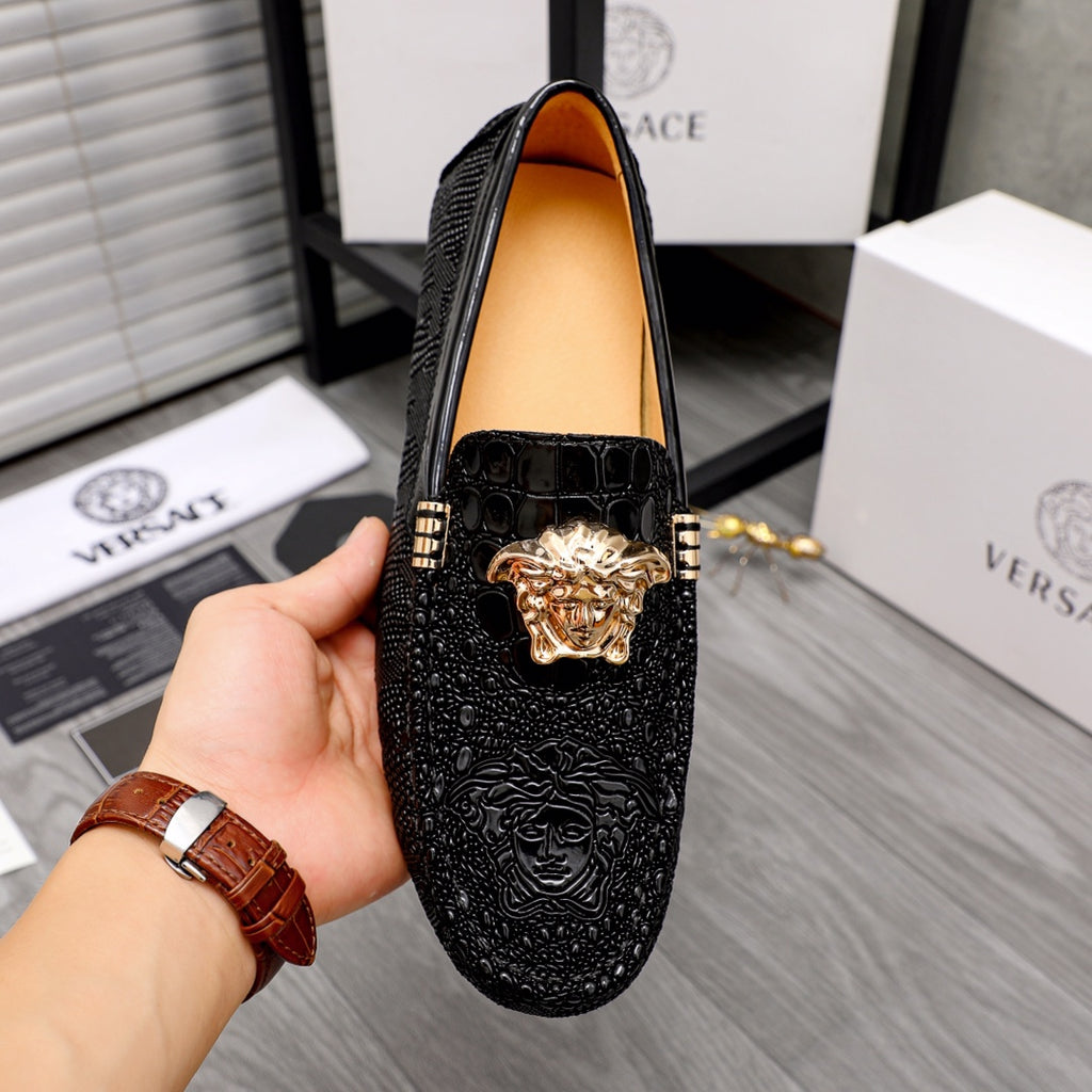 Versace black loafers with gold Medusa head front ornament, tan lining