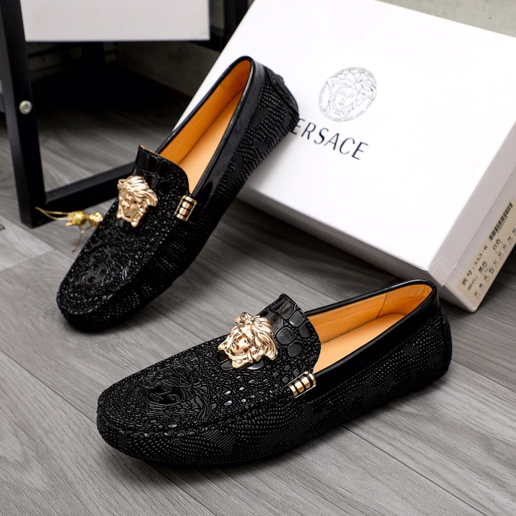 Versace black loafers with gold Medusa head ornament and tan interior