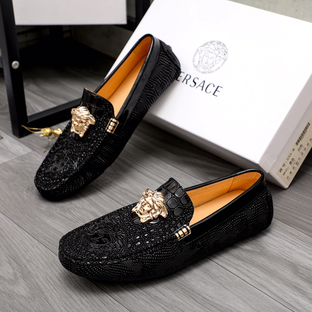 Versace black loafers with gold Medusa head ornament and tan interior