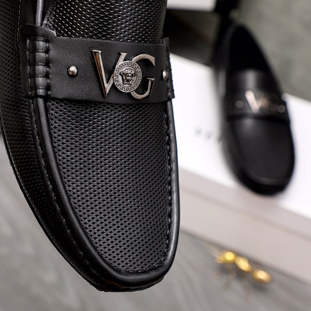 Versace black slip-on loafer close-up of Medusa emblem buckle and vamp texture