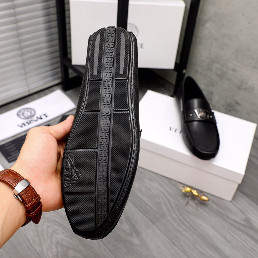 Versace black loafer side sole view with embossed pattern and logo detail
