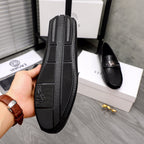 Versace black loafer side sole view with embossed pattern and logo detail