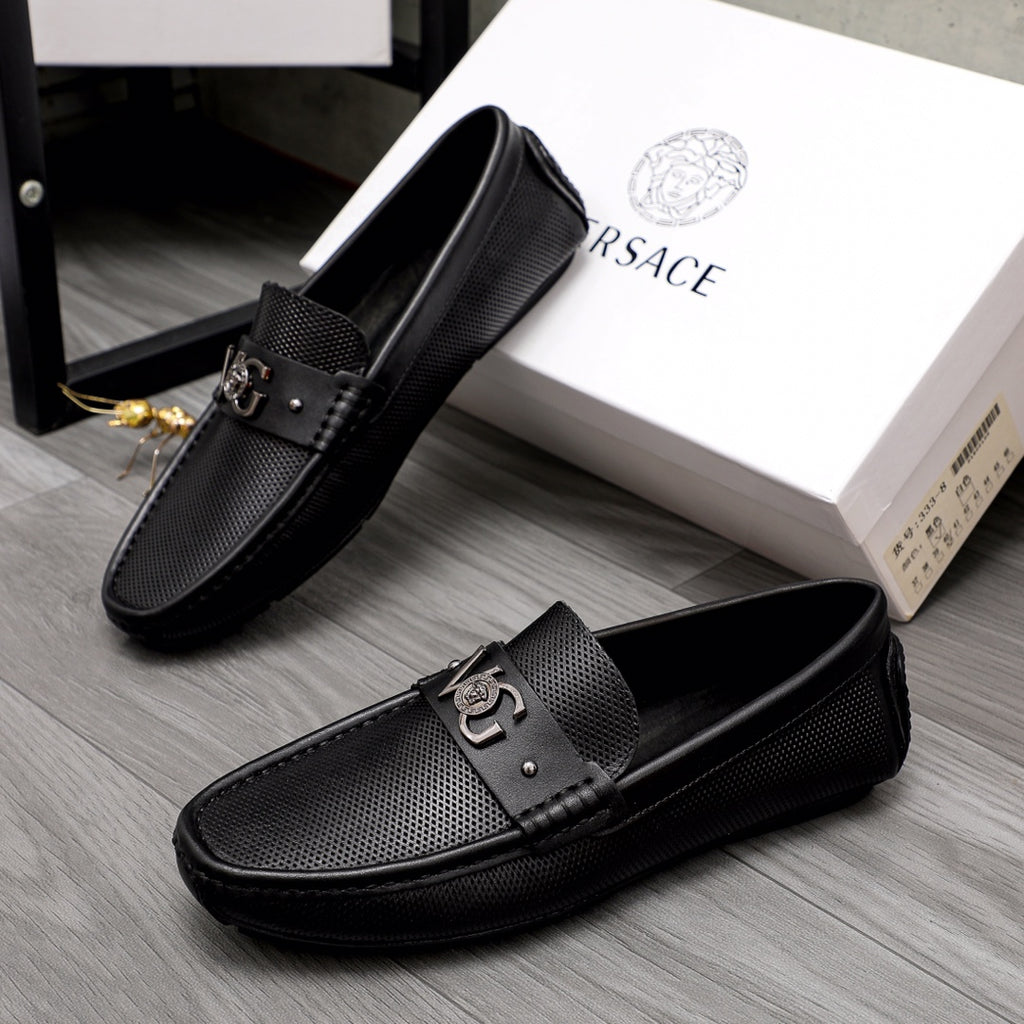 Versace black slip-on loafers pair, front buckle detail and textured panels