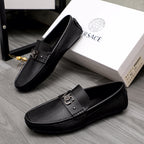 Versace black slip-on loafers pair, front buckle detail and textured panels