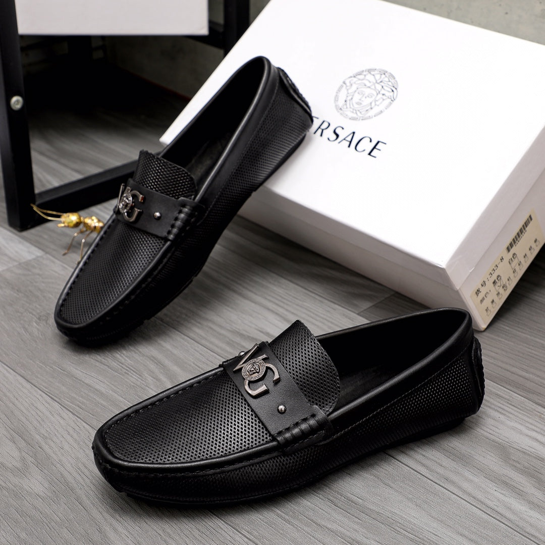 Versace black slip-on loafers pair, front buckle detail and textured panels