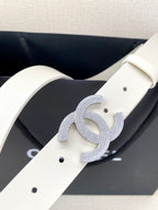 Chanel belt close-up: light cream strap with perforations and glitter CC buckle