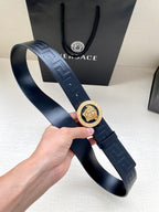 Navy Versace belt with Greca embossed strap and gold lion emblem buckle