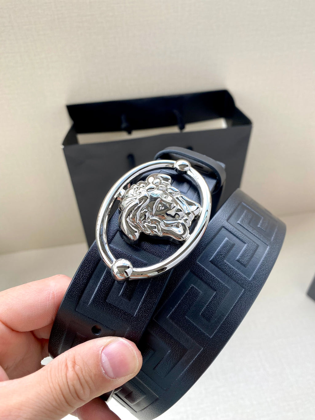 Versace belt detail: embossed strap with silver-tone oval Medusa buckle