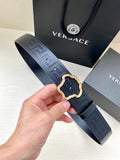 Designer belt in dark navy with embossed pattern and gold ornate buckle frame