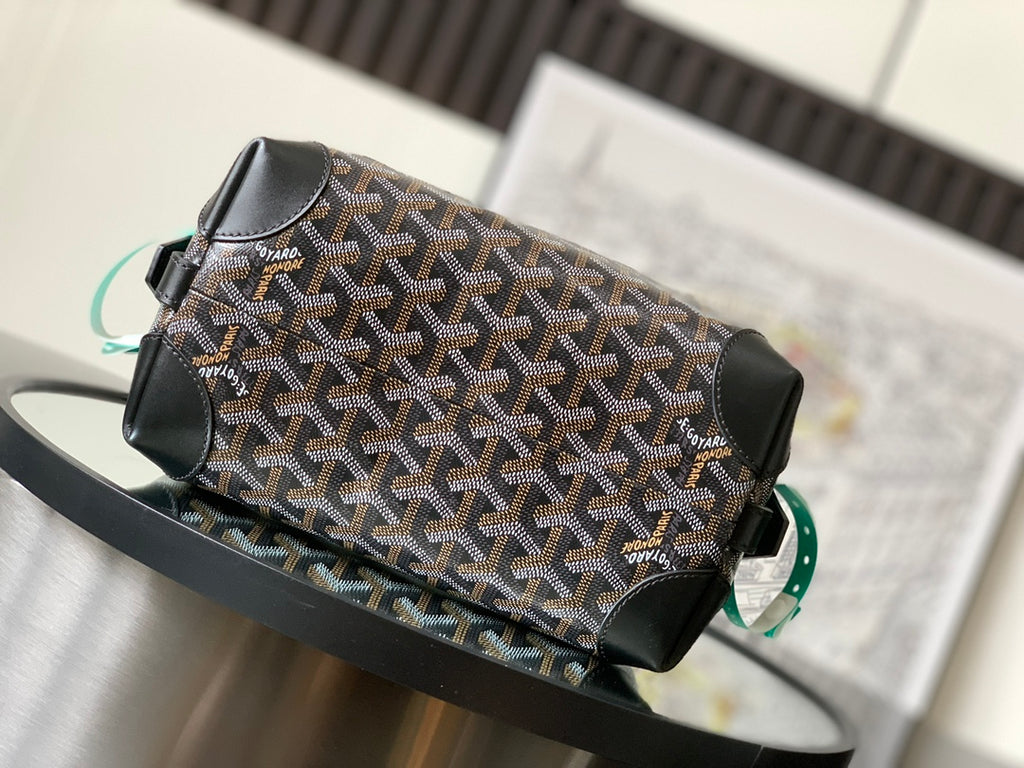 Patterned canvas pouch bag with black leather flap and turquoise-green strap detail