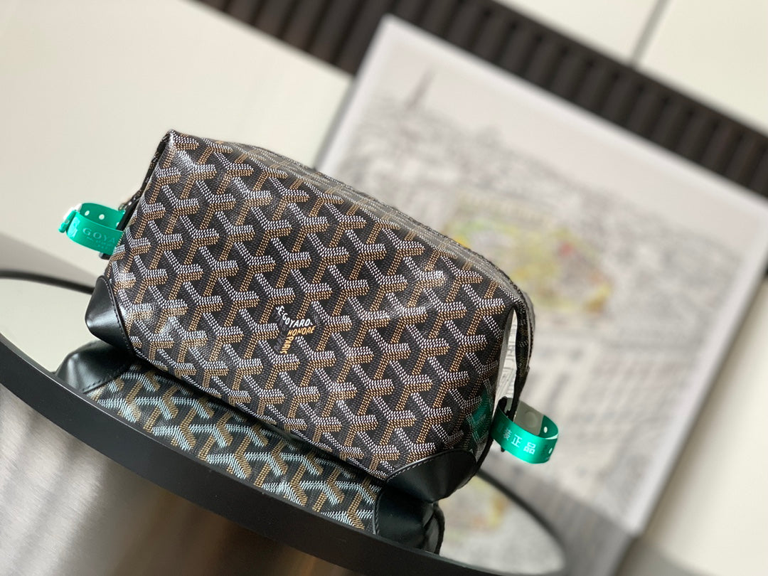 Goyard bag with brown and black patterned canvas, black leather trim, top handle