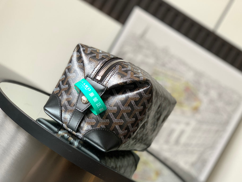 Patterned canvas pouch bag with black leather base and turquoise label at front
