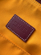 Goyard bag leather brand label on orange fabric reading “Goyard” and “Made in France”