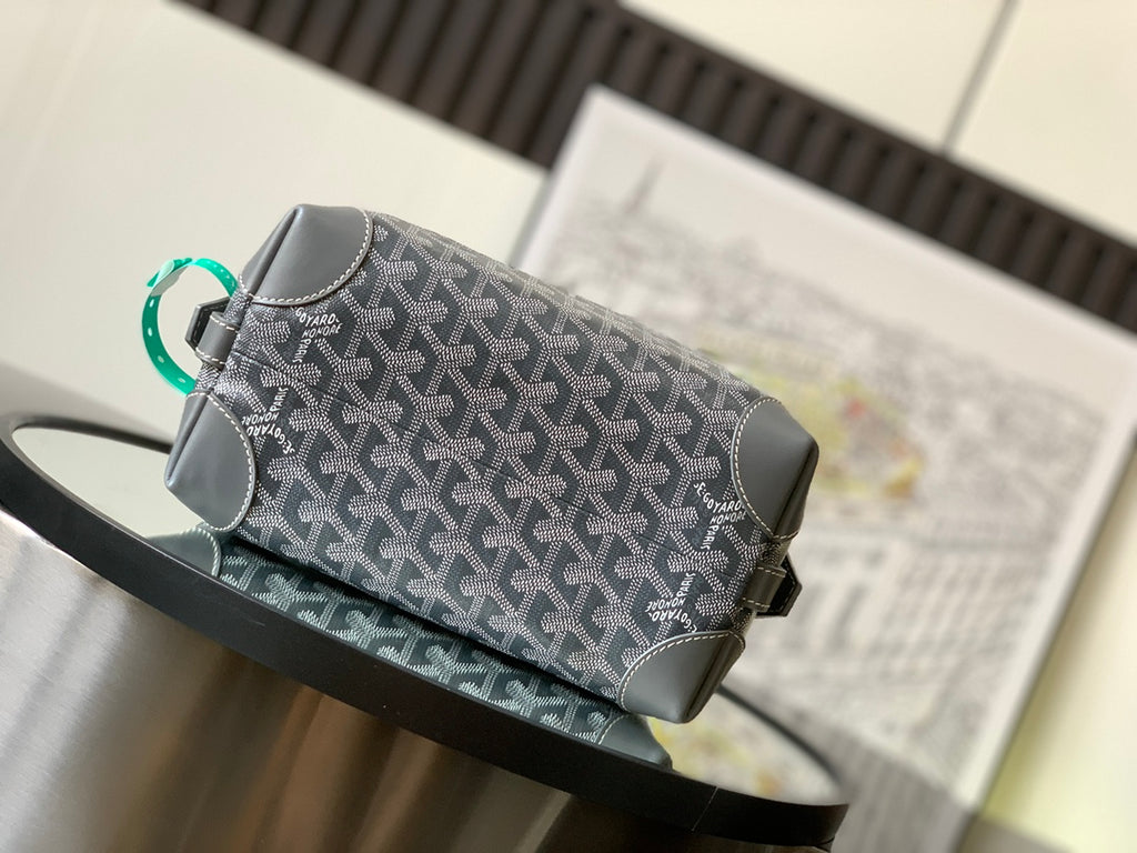 Dark gray patterned crossbody bag with green handle loop and silver zipper
