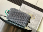 Dark gray patterned crossbody bag with green handle loop and silver zipper