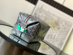 Dark gray patterned pouch bag with silver zipper and green leather pull tab