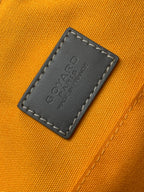 Orange interior lining with embossed leather label patch and dark stitched border
