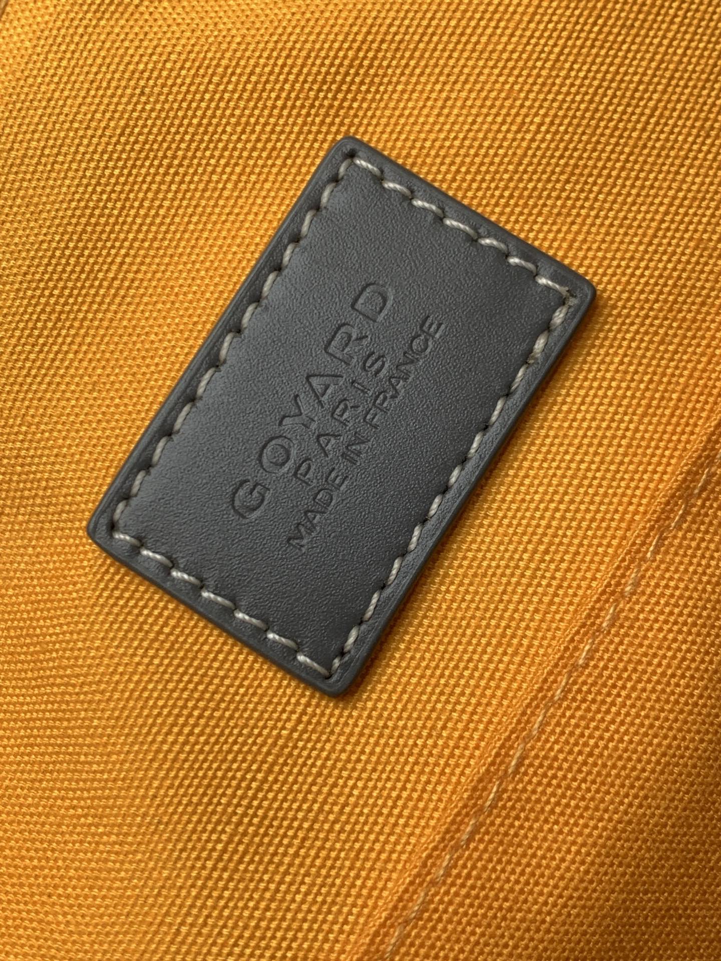 Orange interior lining with embossed leather label patch and dark stitched border