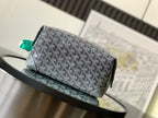 Dark gray patterned crossbody bag with front emblem and green strap loops