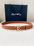 Brown leather belt with gold-tone CC logo buckle, laid flat