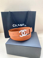 Brown leather belt with gold-tone CC logo buckle and perforated holes