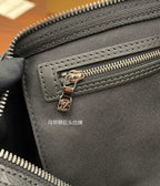 Louis Vuitton monogram pouch detail with gold-tone zipper pull and stitched edge