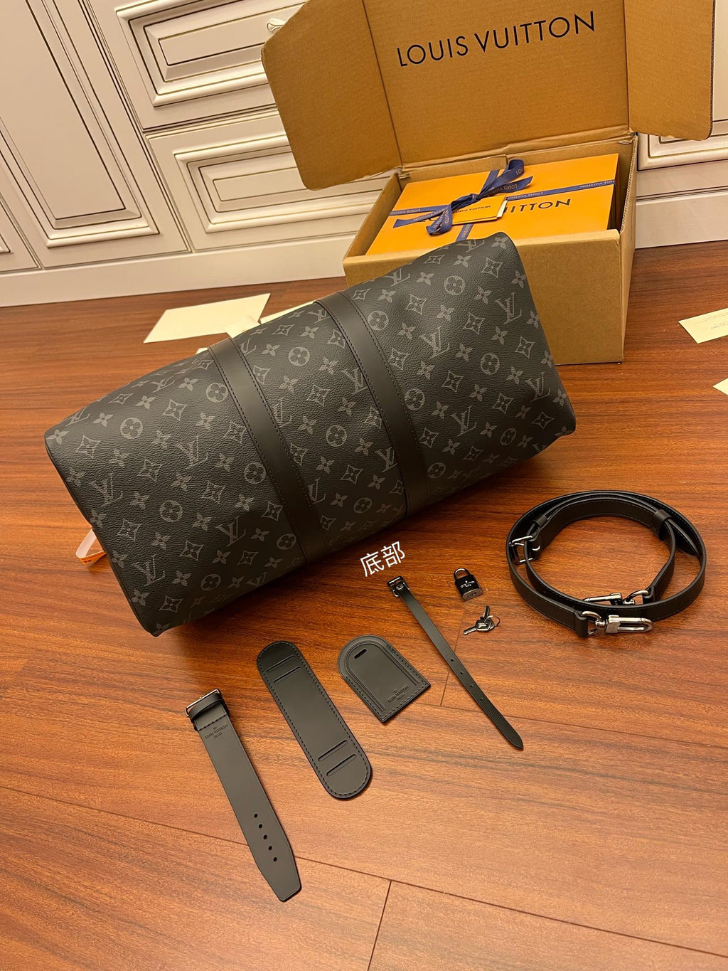 Men's Louis Vuitton duffel bag, dark gray monogram canvas, with included leather strap pieces.